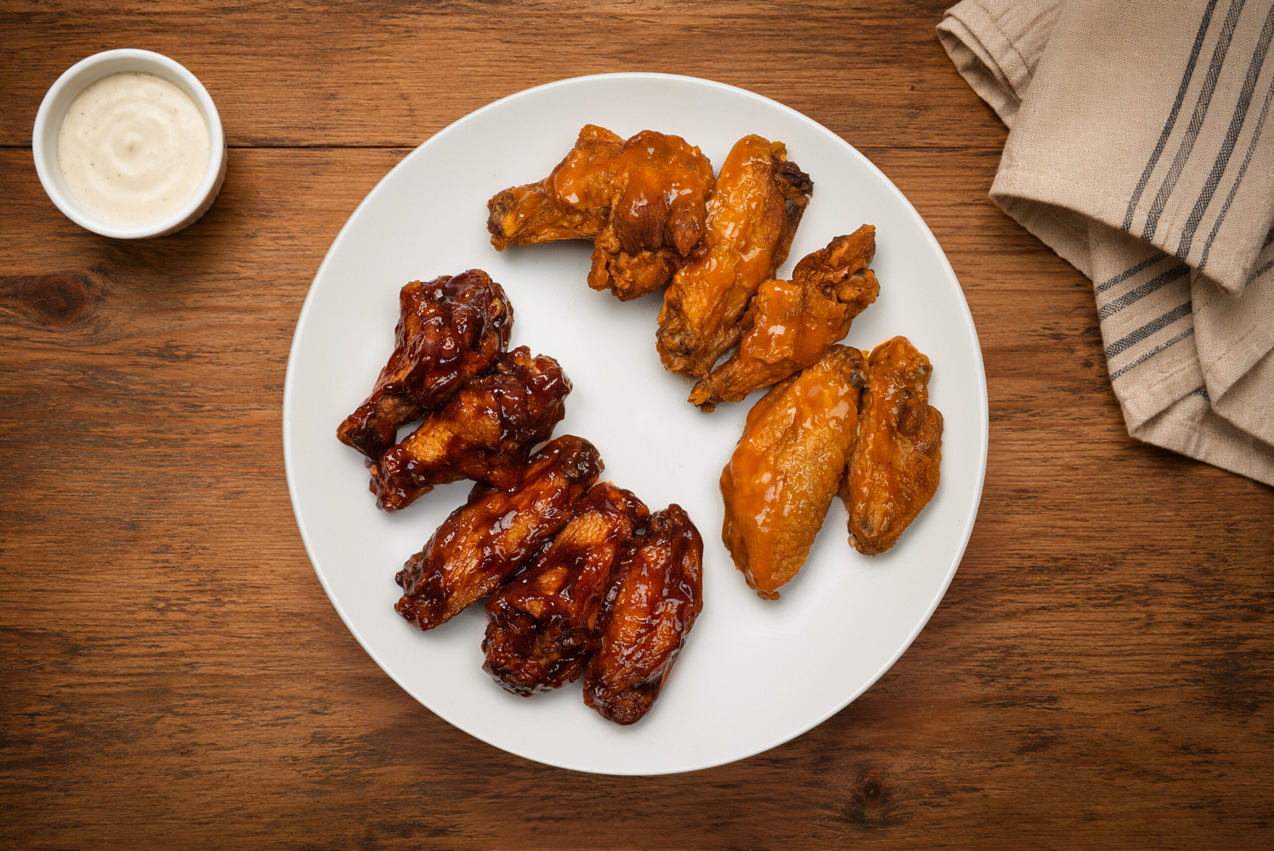 Ten sauced chicken wings plated for restaurant menu photography