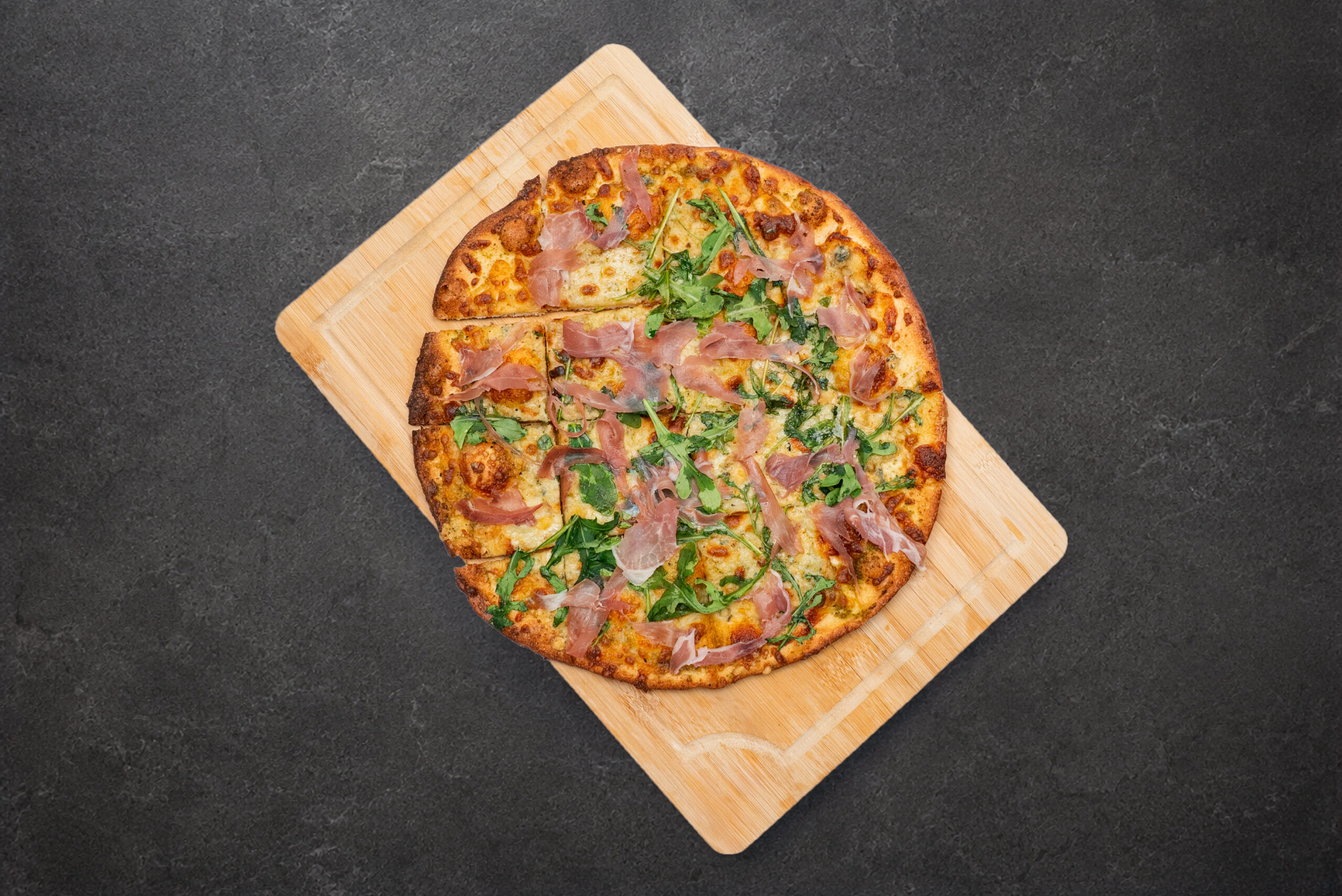 Prosciutto and arugula pizza
