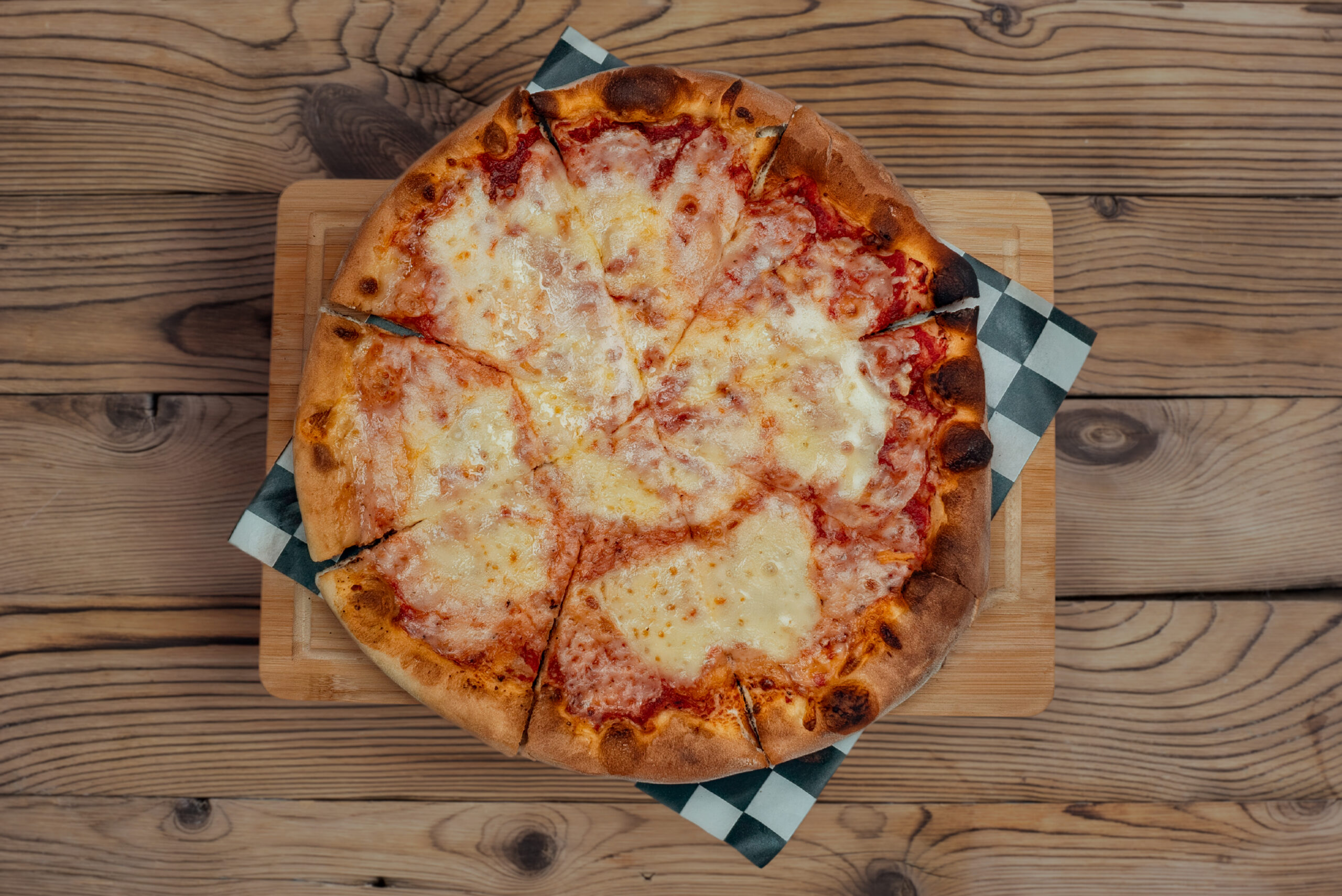 Cheese pizza on a board