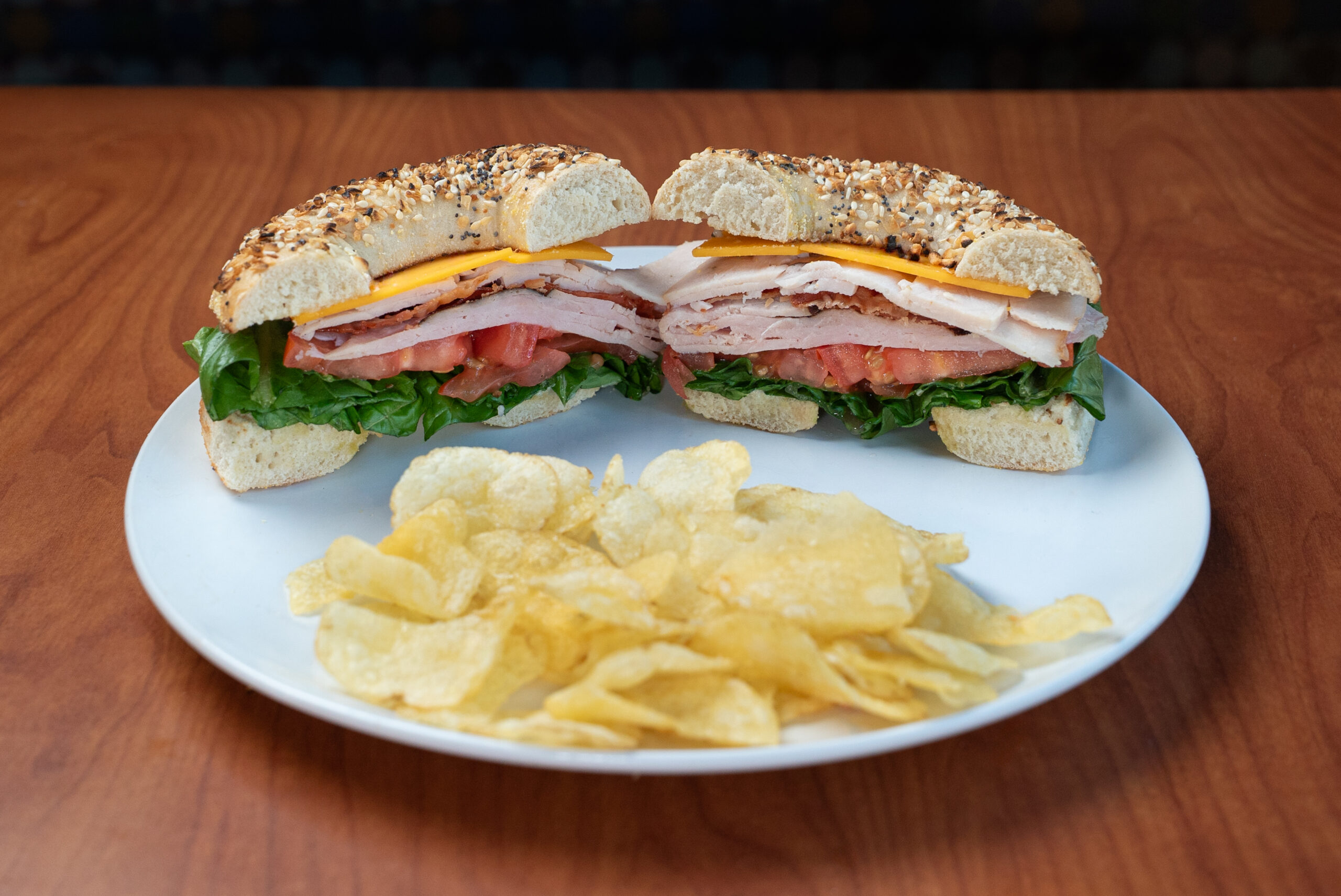 Big Apple Club bagel sandwich with kettle chips — Denver deli food photography by AesthetiCo