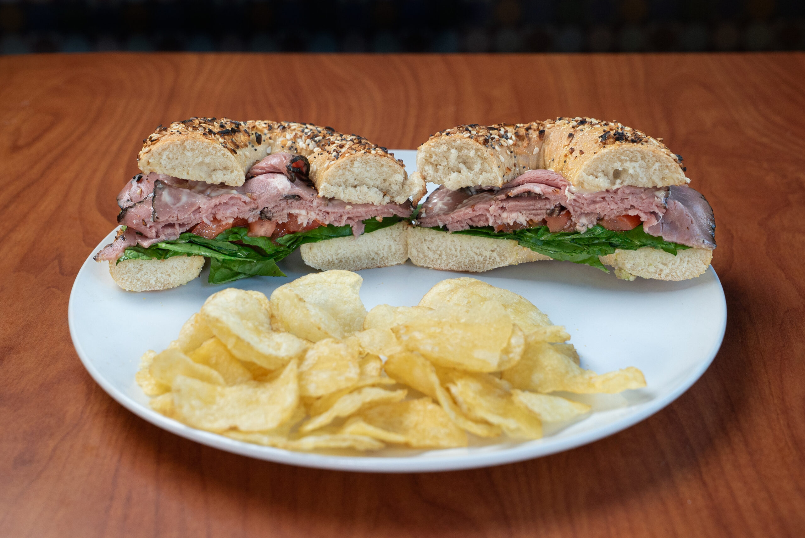 Kick’n roast beef bagel sandwich with kettle chips — Denver deli food photography by AesthetiCo
