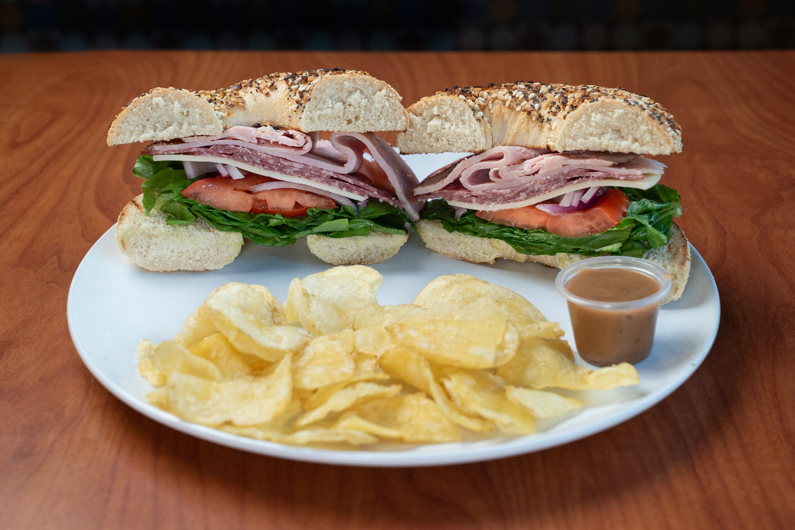 Roma Italian bagel sandwich with kettle chips — Denver deli food photography