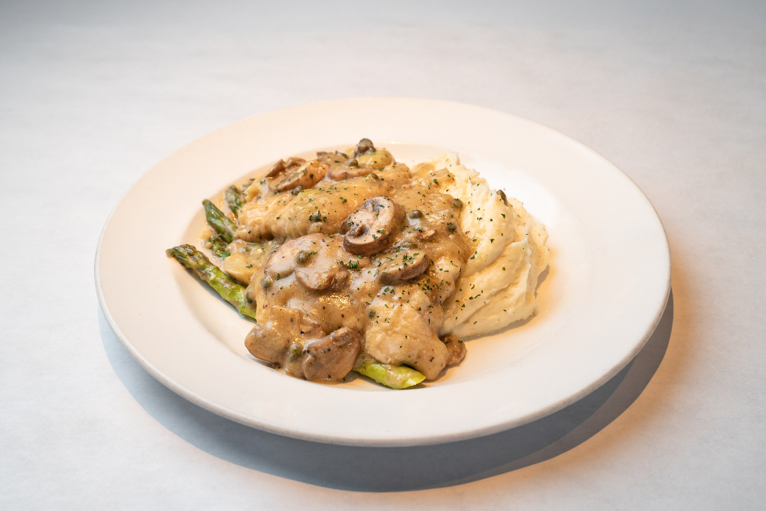 Chicken piccata with mushrooms, capers, asparagus and mashed potatoes — Denver restaurant food photography