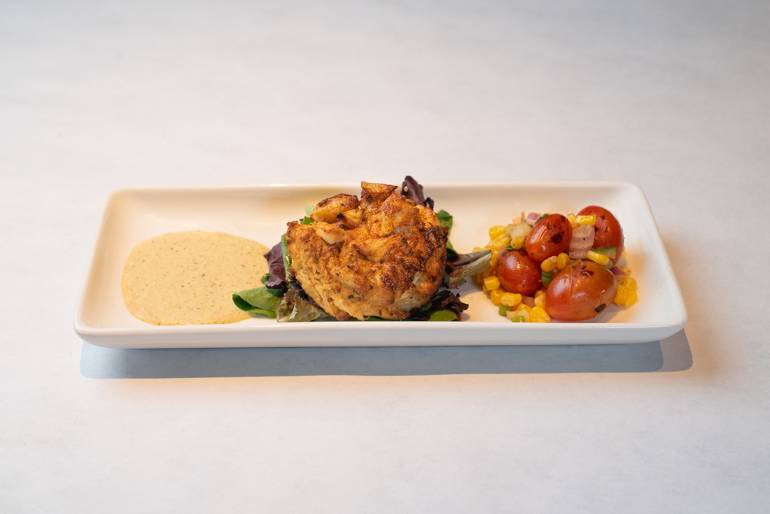Crab cake with remoulade and charred corn salad — Denver restaurant food photography